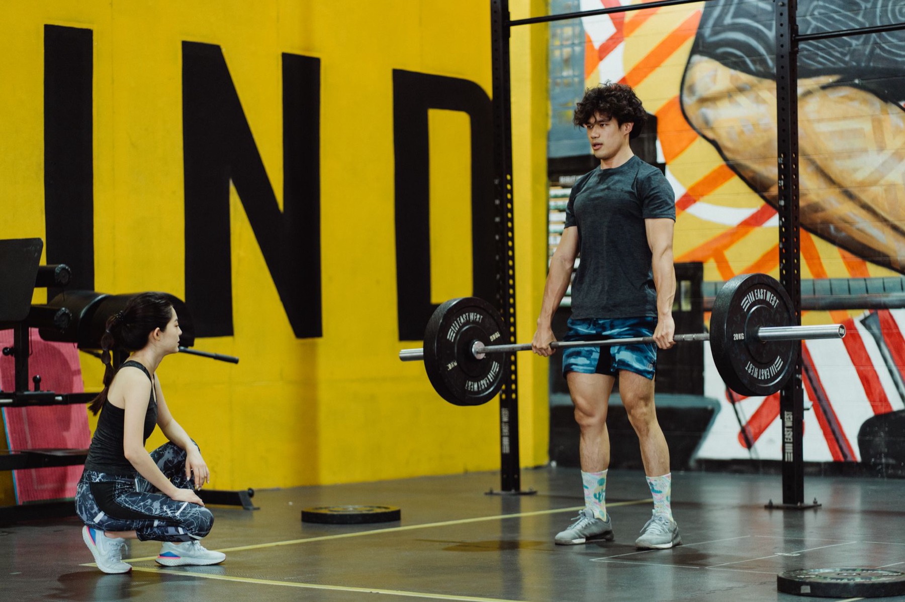 Athlete lifting a loaded barbell in a gym